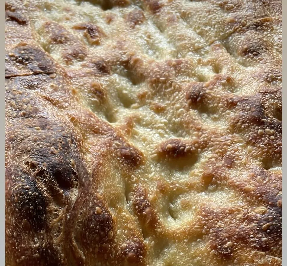 Sourdough focaccia, dimpled and golden, straight from the oven