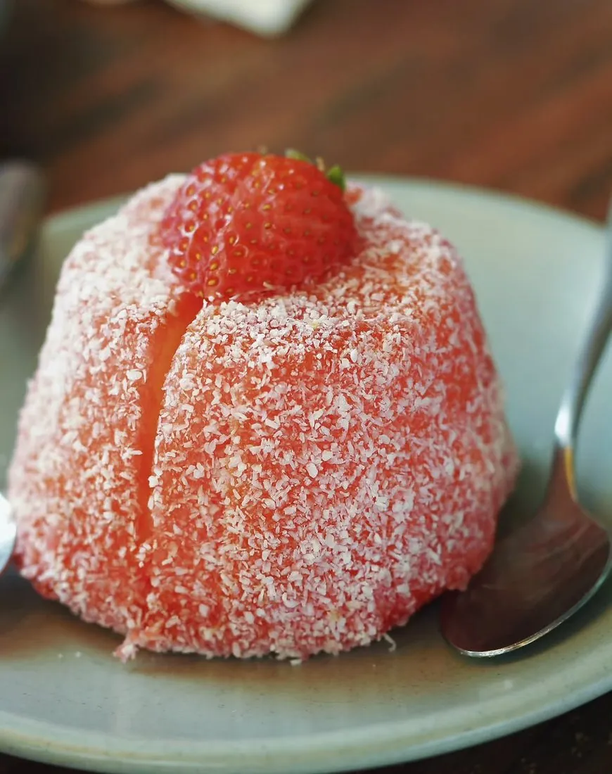 Strawberry lamington on a green plate