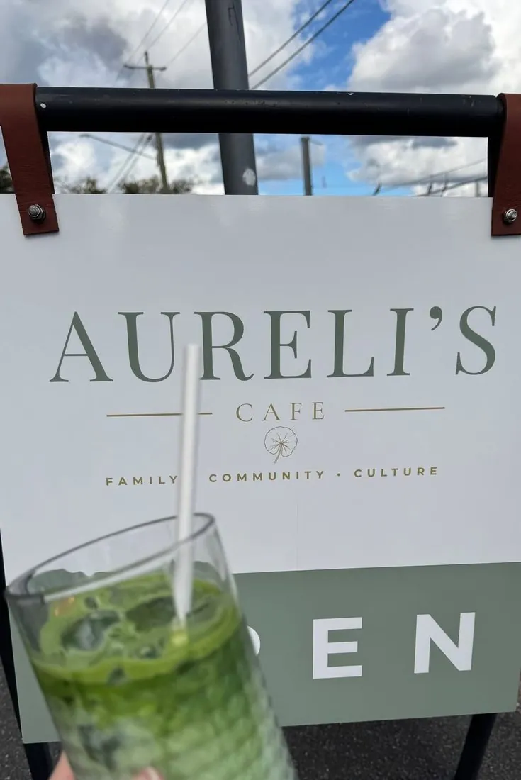 The Aureli's Cafe sign on the footpath, open